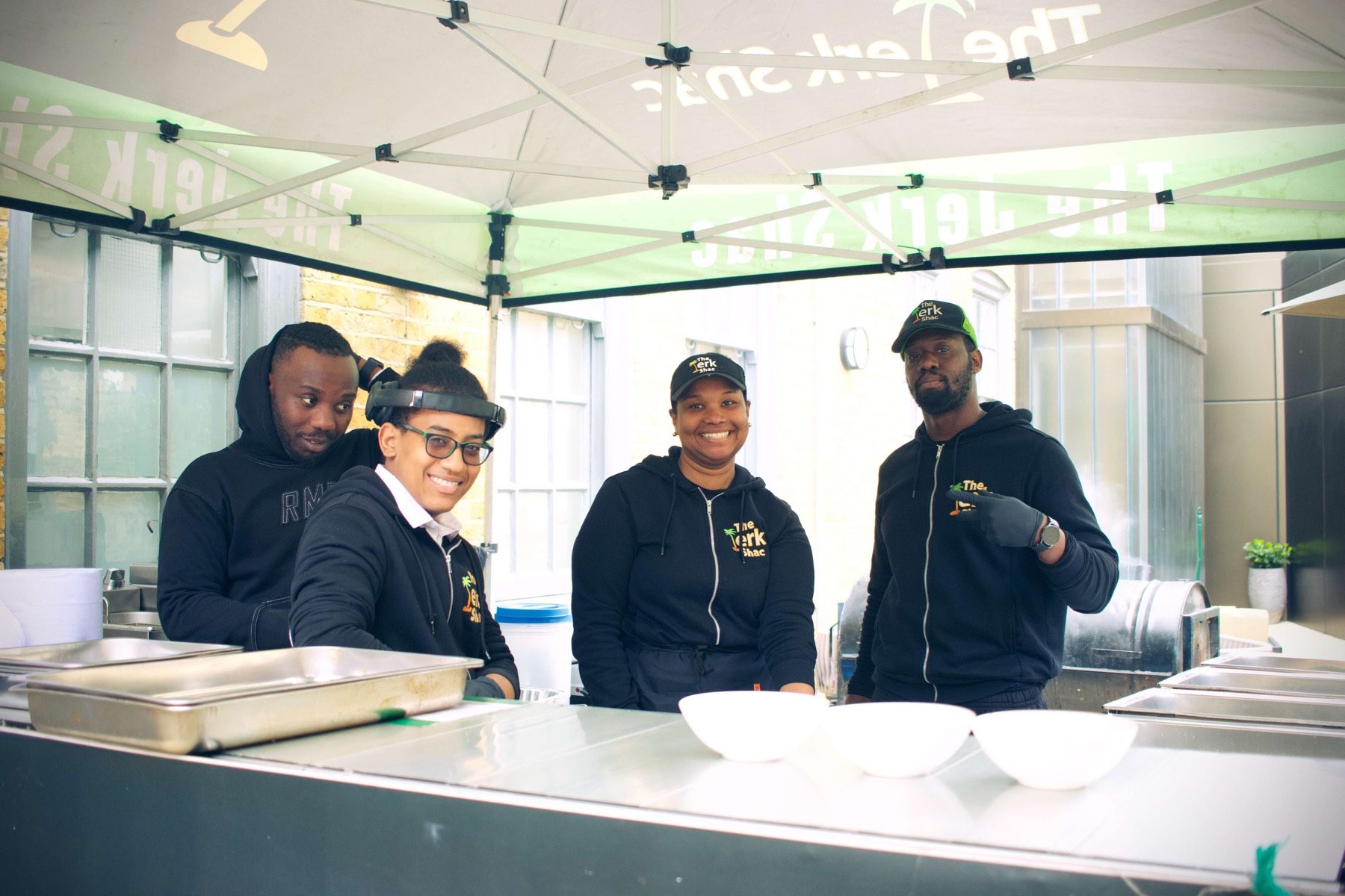 The Jerk Shac catering team serving at an outdoor event